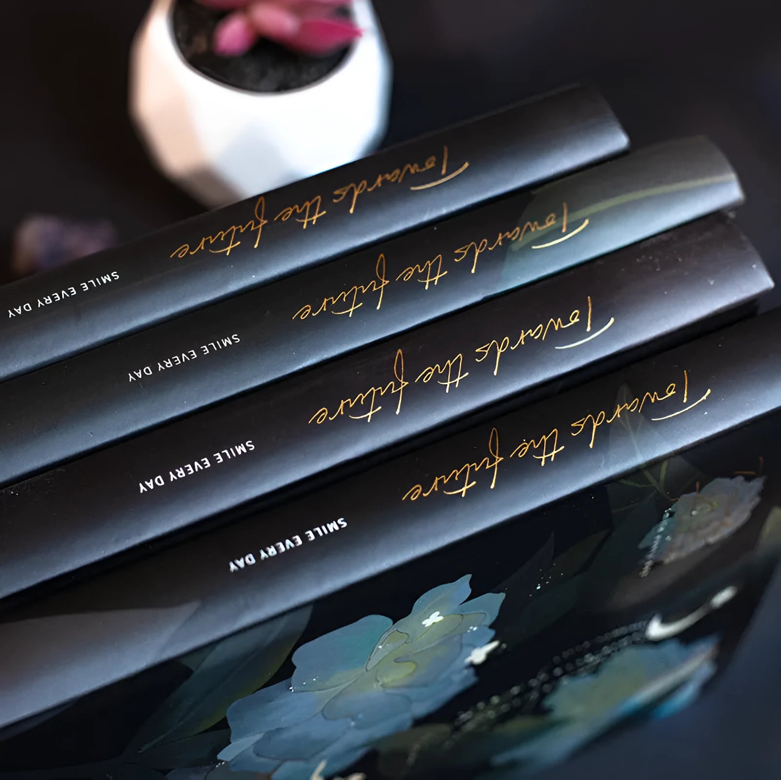 A5 notebook with luminous cover showing colour illustrations on open pages