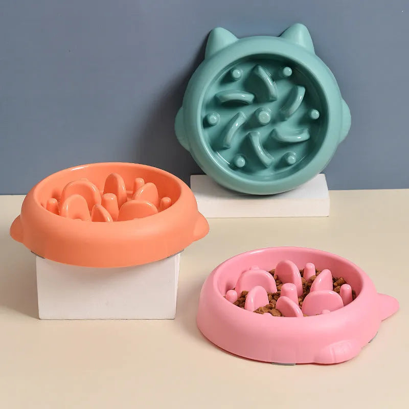 Green plastic slow feeder dog bowl with raised bone-shaped ridges inside.