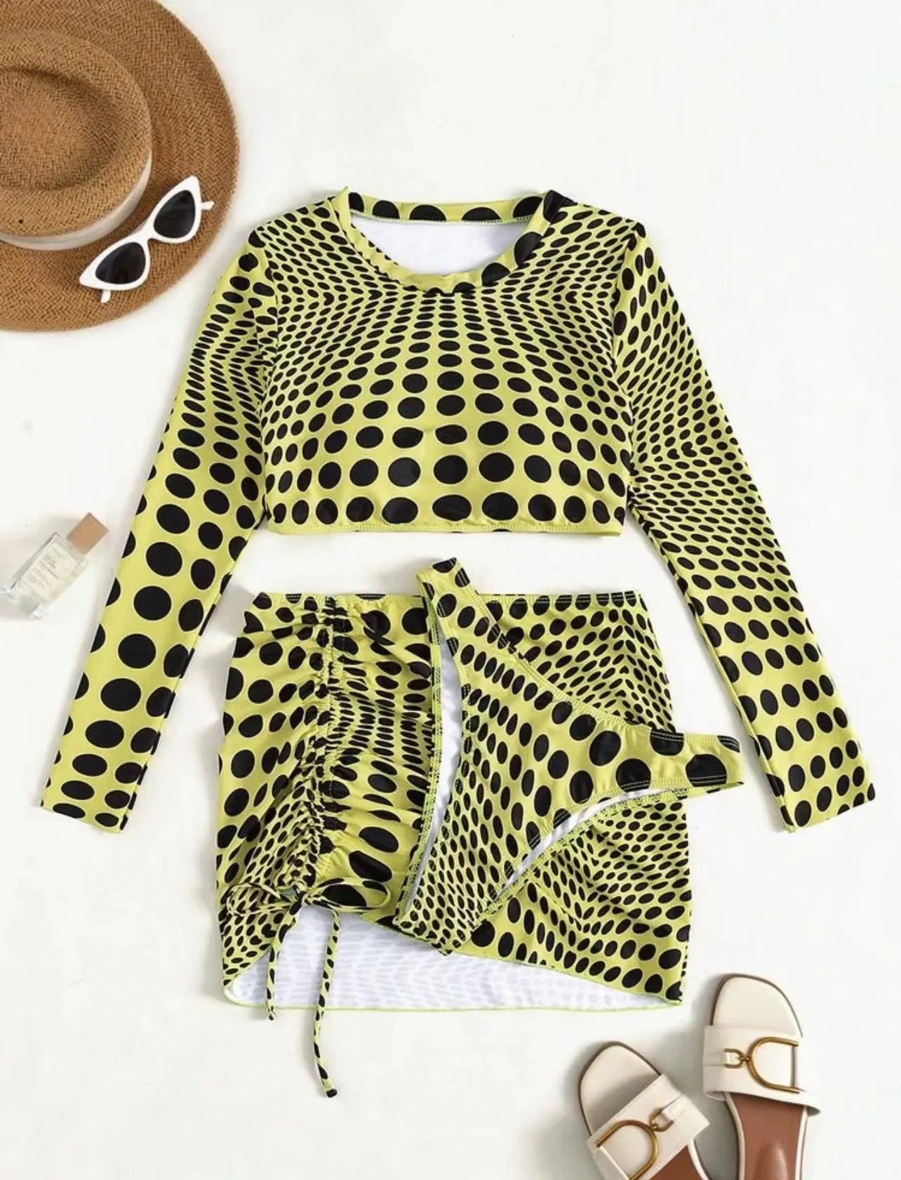 Green polka dot women's three-piece swimsuit set showing bikini top, skirt, and bra.