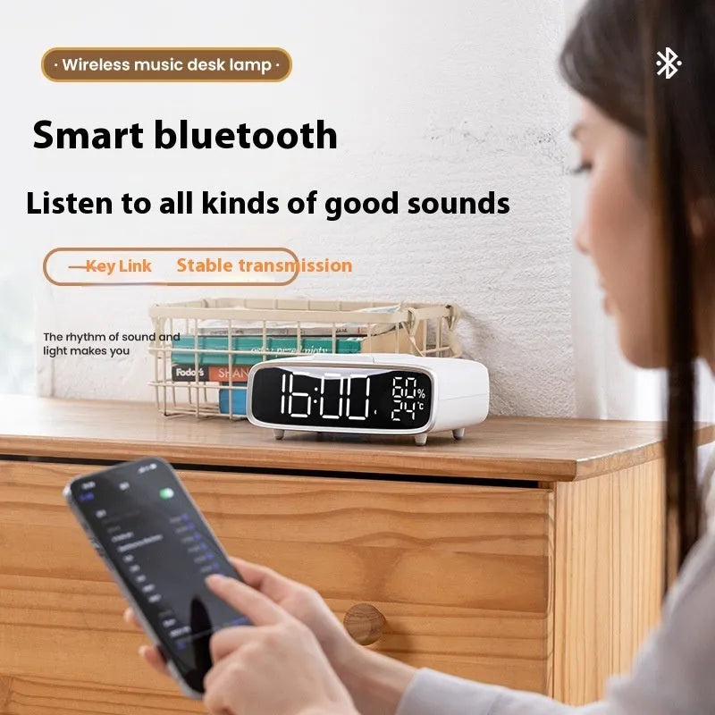 White wireless charger Bluetooth speaker with night light functionality on wooden surface