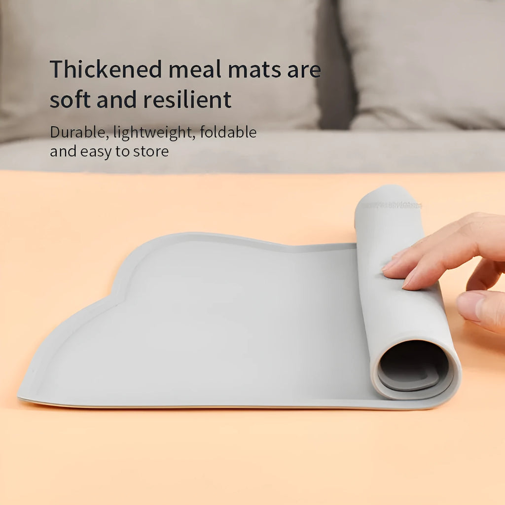 Blue waterproof silicone pet feeding mat for dog or cat bowls on a wooden floor.