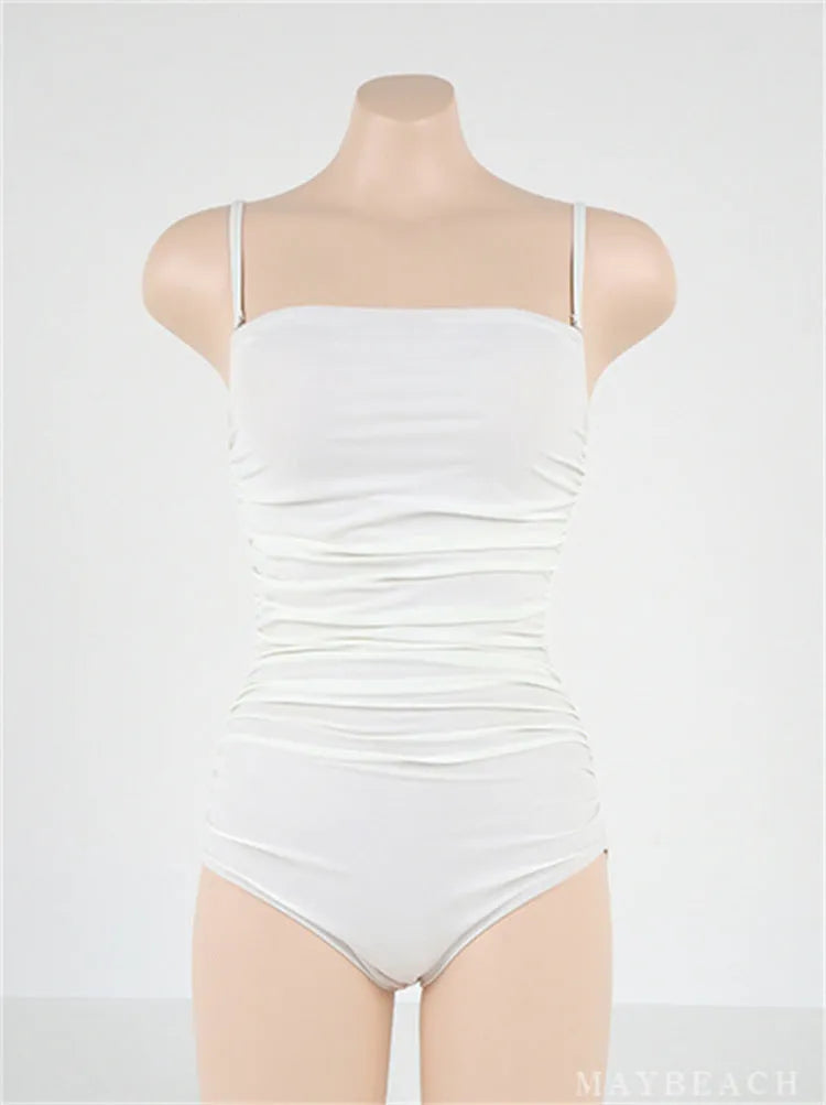 Women's blue sling style one-piece swimsuit with a belted pleated waist detail on a model.
