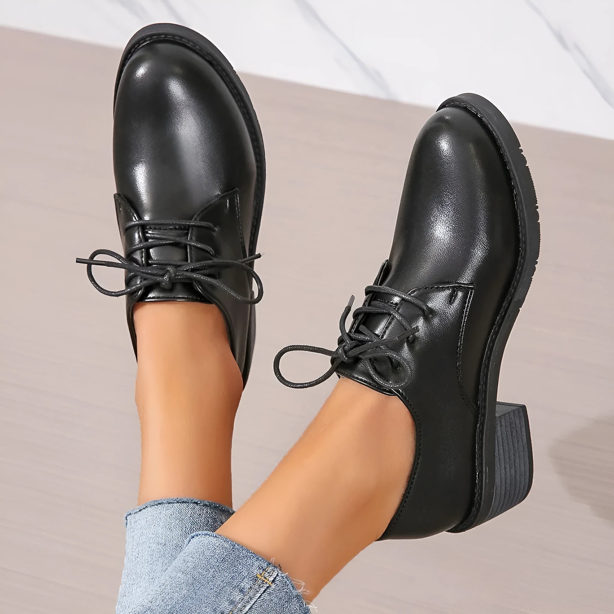 Black women's low-top work shoes with a thick chunky mid-heel and rubber sole.