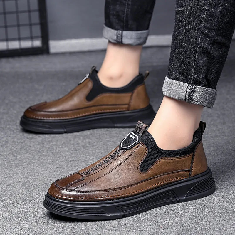 Men's solid colour leather casual shoes with round toe in black and brown on a white background.