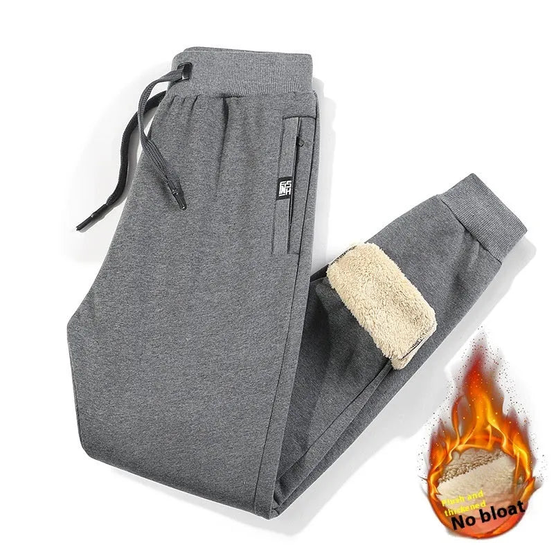 Men's grey fleece-lined oversized track pants with elastic waistband and straight leg cut