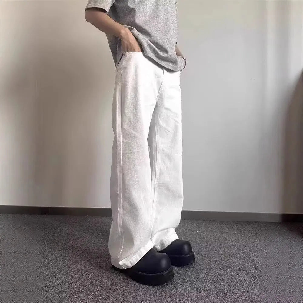Men's white straight-leg cotton denim jeans on a hanger, showing front view with zipper fly.