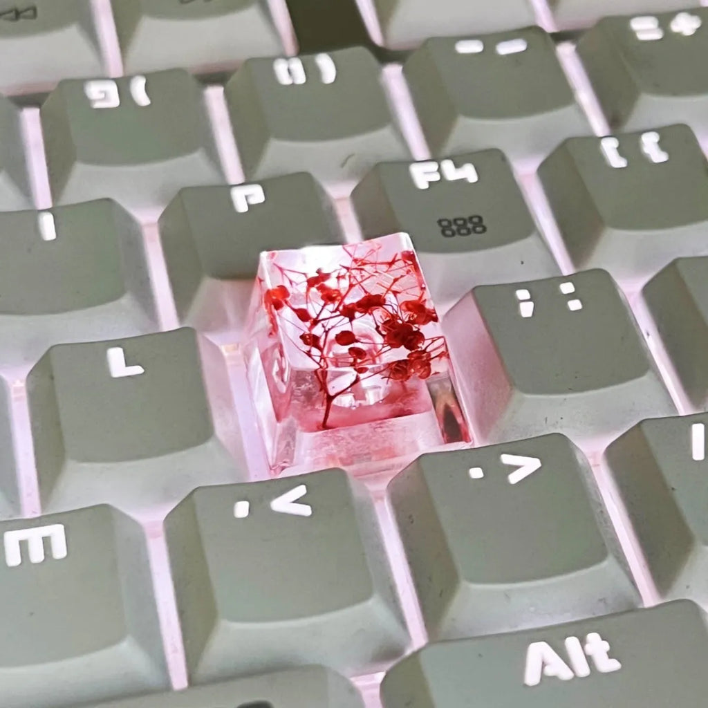 Green resin transparent keycap with glitter starry sky design for mechanical keyboards.