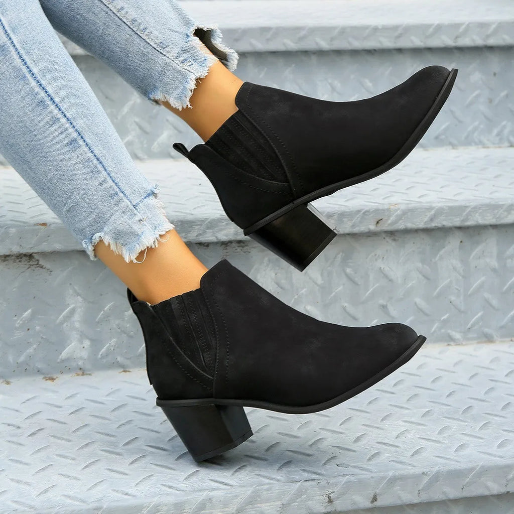 Women's black pointed toe ankle boots with thick square low heel slip-on design