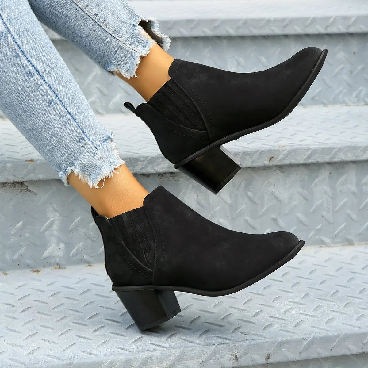 Women's black pointed toe ankle boots with thick square low heel slip-on design