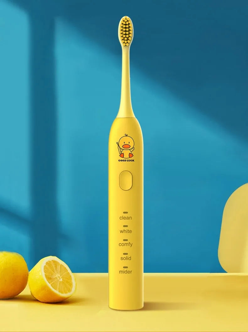 Yellow rechargeable electric toothbrush with small duck design, soft bristles, and a compact size.