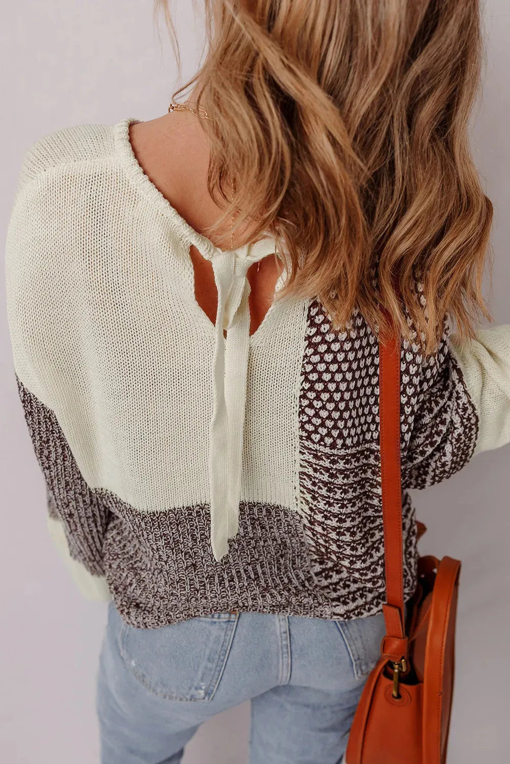 Dark khaki loose knit sweater with drop shoulders and a back tie detail.