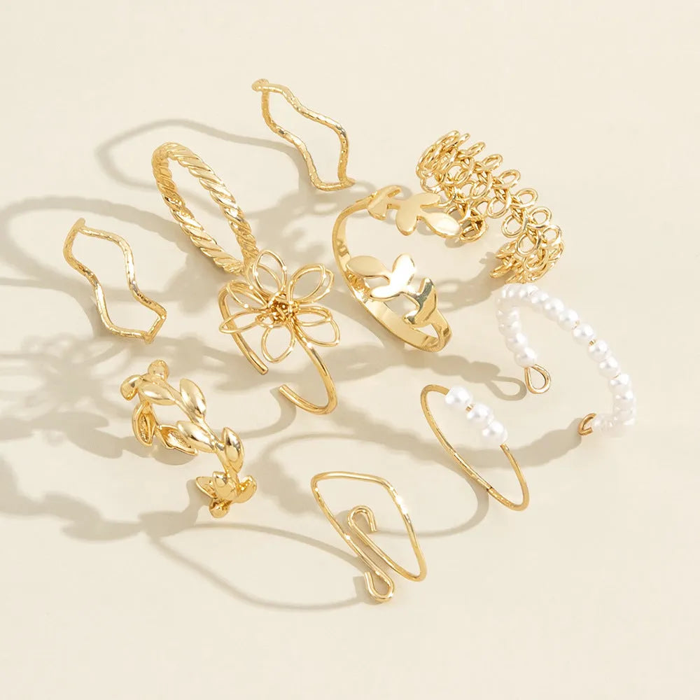 Gold colour openwork flower ring with electroplated glossy finish and floral design