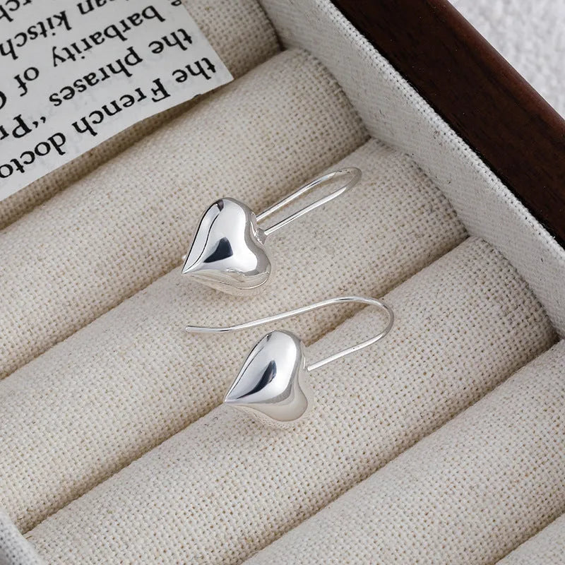 Korean style heart-shaped earrings with glossy finish and silver colour