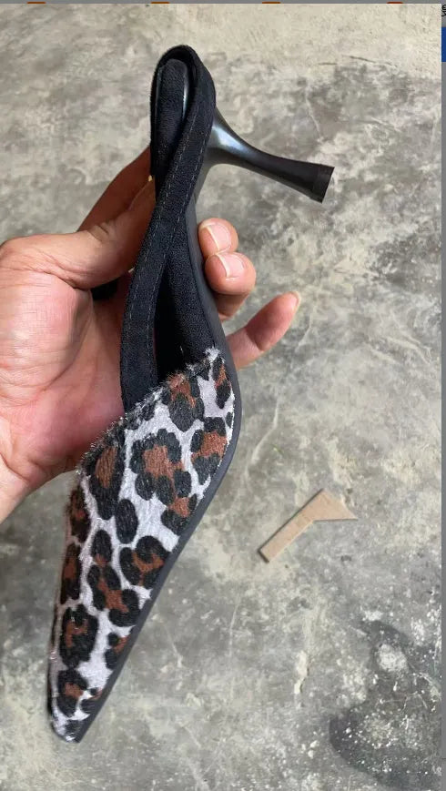 Women's leopard print suede sandals with a pointed toe and high heel.