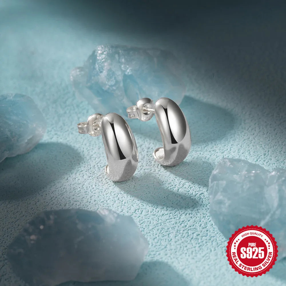 Sterling silver C-shaped stud earrings with glossy electroplated finish in gold or white gold