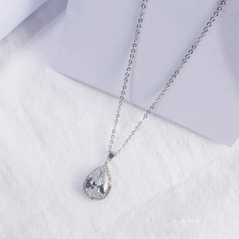 Women's alloy water drop necklace with rose gold electroplated colour and rhinestone inlays on a geometric pendant.