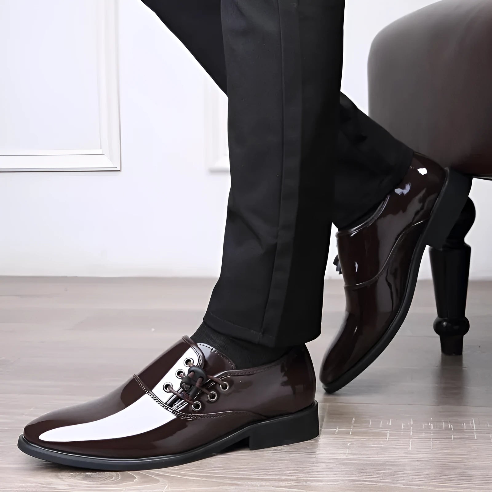 Men's black and brown formal slip-on shoes with round toe and square heel on a rubber sole.