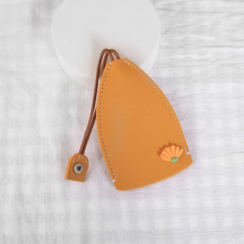 Colourful cartoon pull-out key protector case made from PU leather, showing a selection of fruit and animal designs.