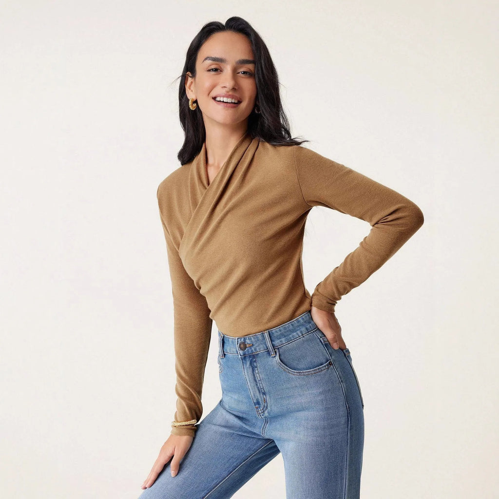 Camel coloured women's slim fit long sleeve pullover sweater on a hanger
