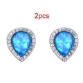 Blue opal drop-shaped stud earrings on copper base with inlaid gem setting