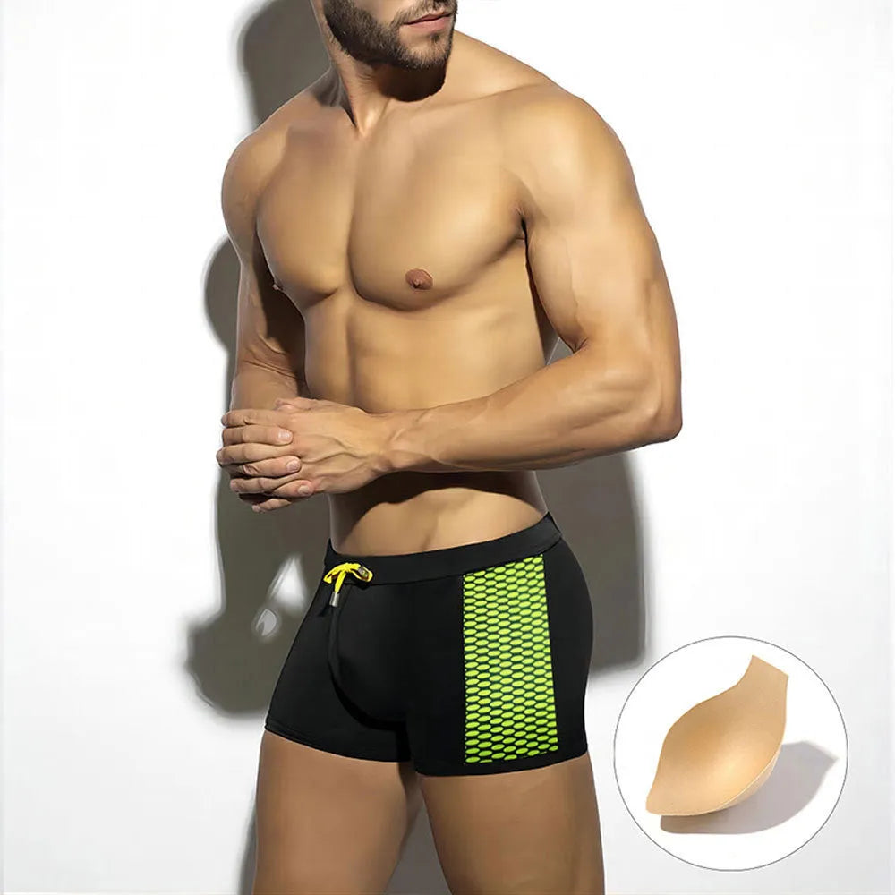 Men's black polka dot quick-dry swimming boxers briefs on a white background.
