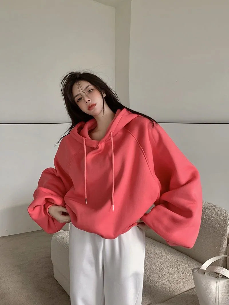 Watermelon red women's silk hooded sweater on hanger showing sleeveless design