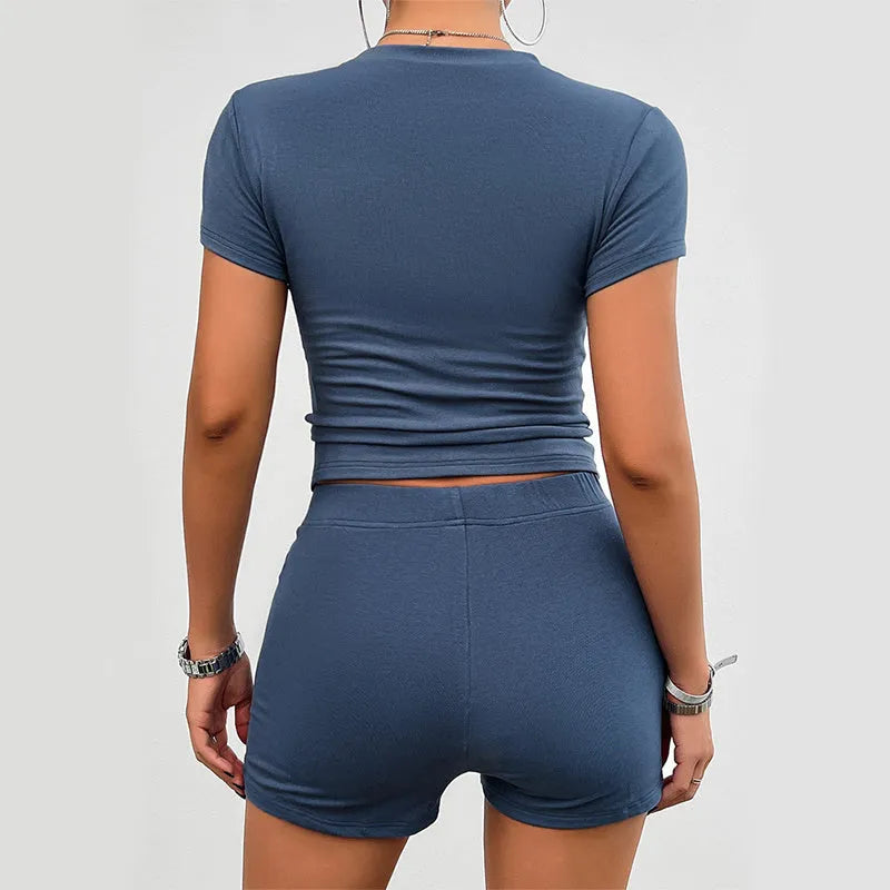 Women's slim fit solid colour viscose sportswear set with short sleeve T-shirt and elastic shorts.