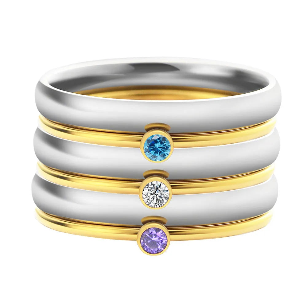 Geometric titanium steel ring with superimposed December birthstones and engraved detail.