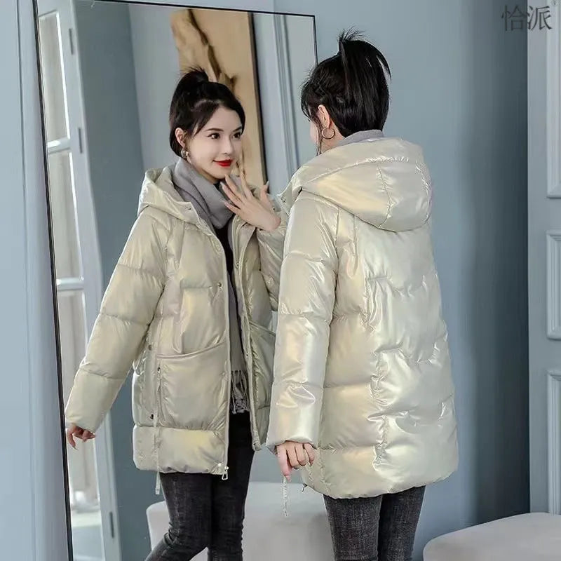 Women's loose thick hooded winter jacket in green colour shown on a model.