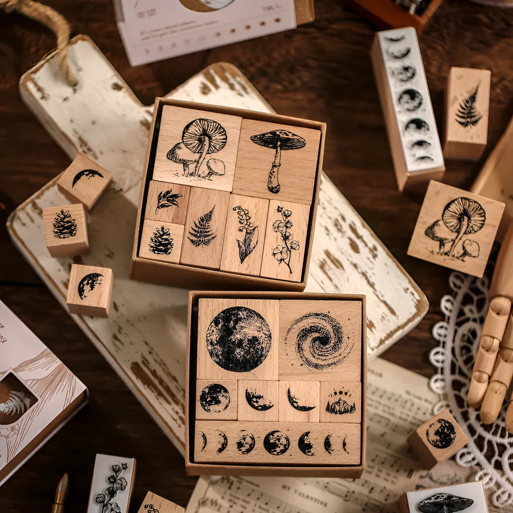 Wooden decorative stamp set with seven hand-carved botanical or celestial designs for paper crafts