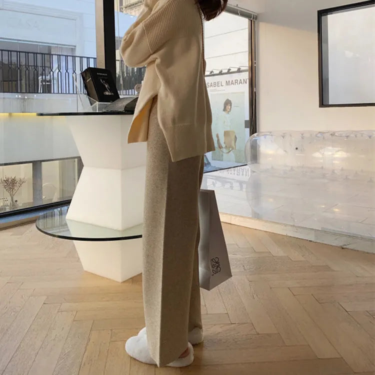 Women's cream white knitted wide-leg high-waist trousers laid flat, showing long straight-leg mopping style.