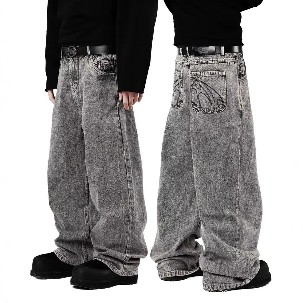 Grey loose straight-leg denim trousers showing mid-waist design on mannequin