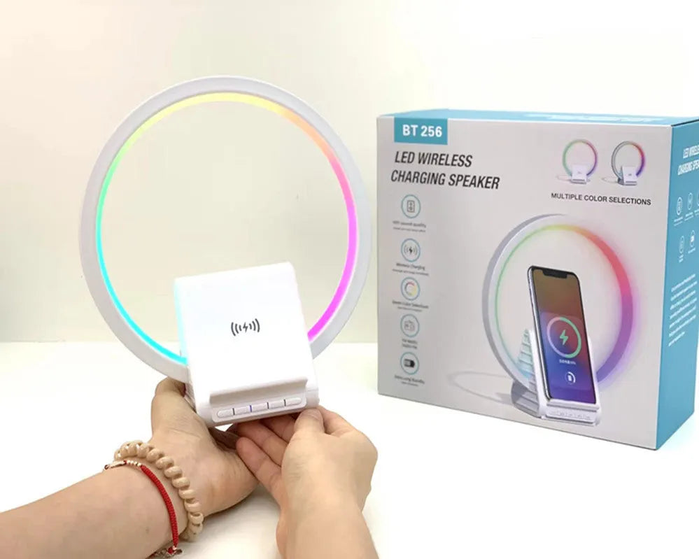 White smart Bluetooth speaker with 15W wireless charging surface and USB port on desktop