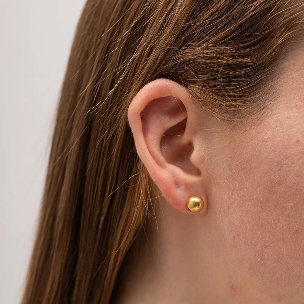 Stainless steel ball stud earrings in gold and silver tones showing 3mm to 6mm size variations