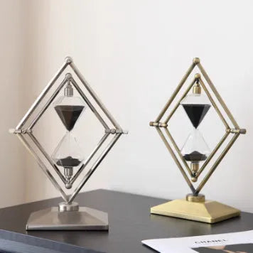 Modern glass sand timer with metal ornament stand in bronze and silver finish options.