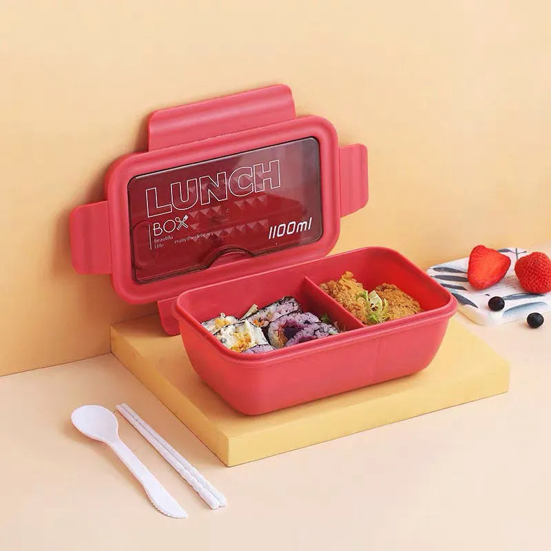 Green Nordic-style plastic bento lunch box with four separate food compartments.