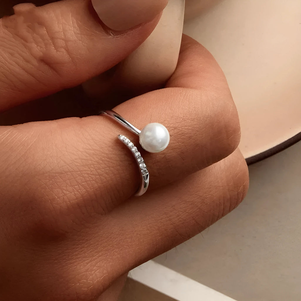 Adjustable sterling silver ring with natural shell pearls on open loop design