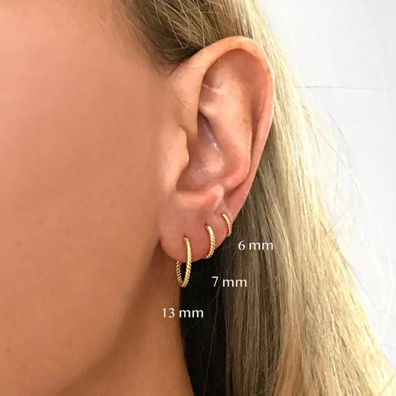 S925 sterling silver twisted string round earrings in gold and white gold finishes showing geometric design