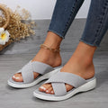Black women's flat wedge peep-toe slippers with a thick rubber sole and PVC upper.
