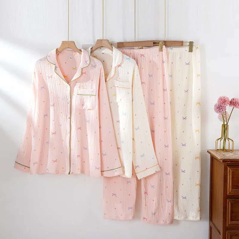 Women's cotton pajamas set in pink with long sleeves and trousers on hanger