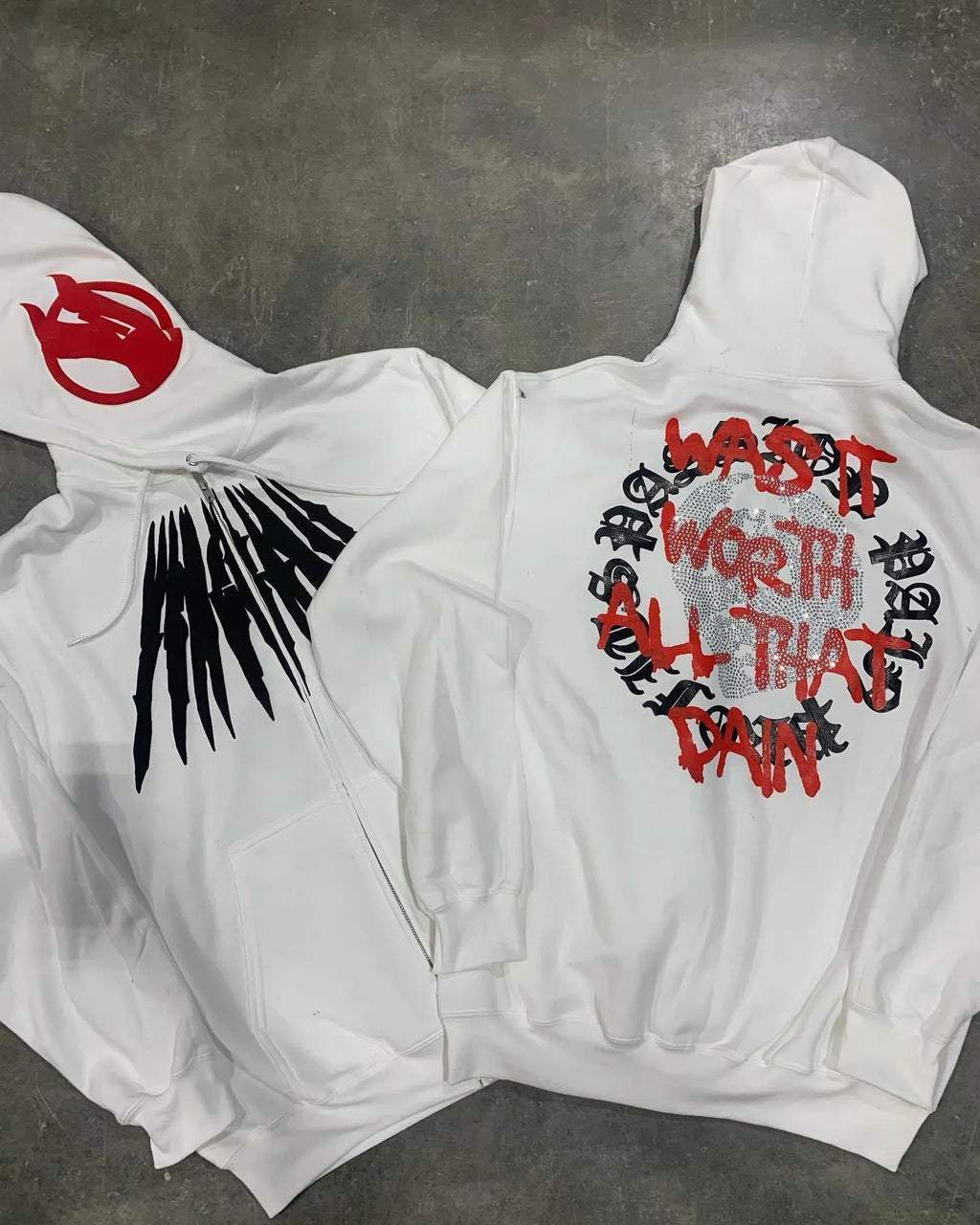 Black hooded sweatshirt with white printed skull design and rhinestone details, loose cardigan style