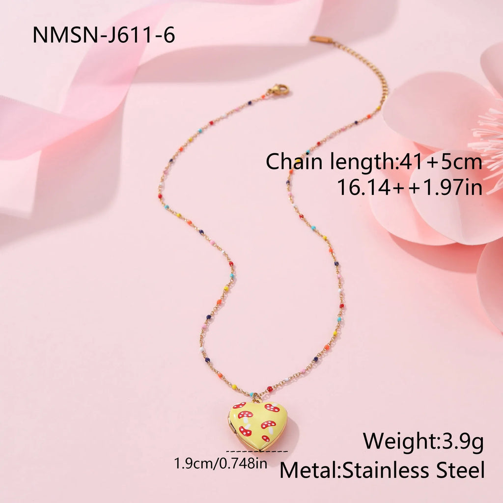 Stainless steel necklace with gold plated heart pendant featuring fruit design on adjustable chain