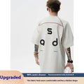 Man's loose fit black cotton T-shirt with large white letter print on the front.