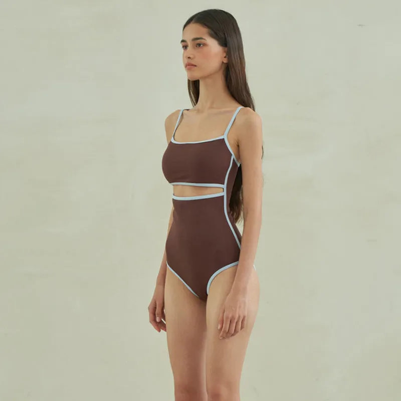 Brown triangle-style one-piece swimsuit for women on a hanger.