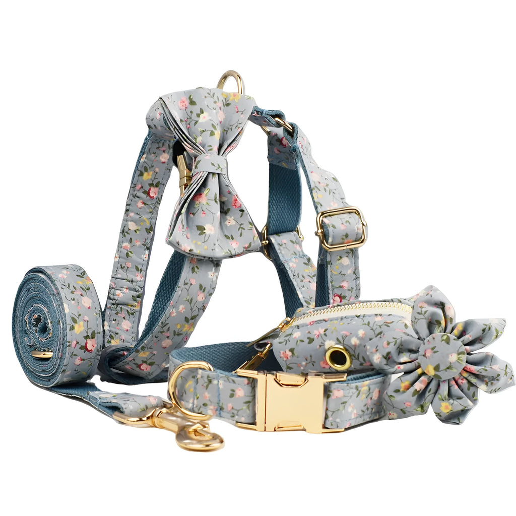 Blue floral patterned cloth dog collar with matching leash and vest set on a white background.