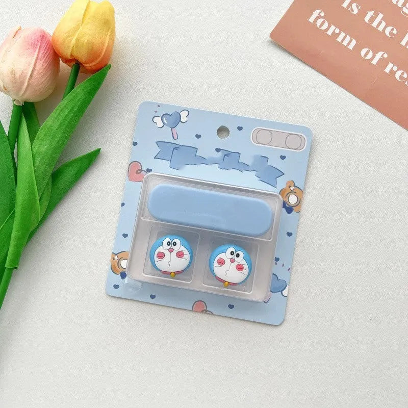 Cartoon magnetic protection data cable fixer in assorted colours on a desktop.