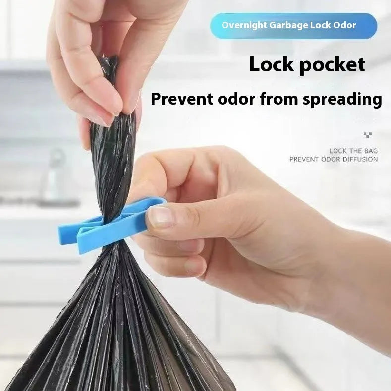 White PP plastic garbage bag fixing clip attached to the rim of a black indoor bin.