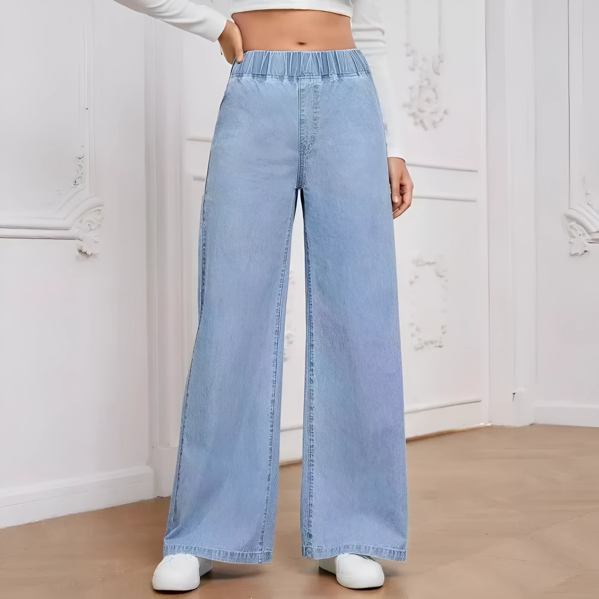 Women's light blue washed wide-leg jeans with straight cut trousers and mid-waist zip fly