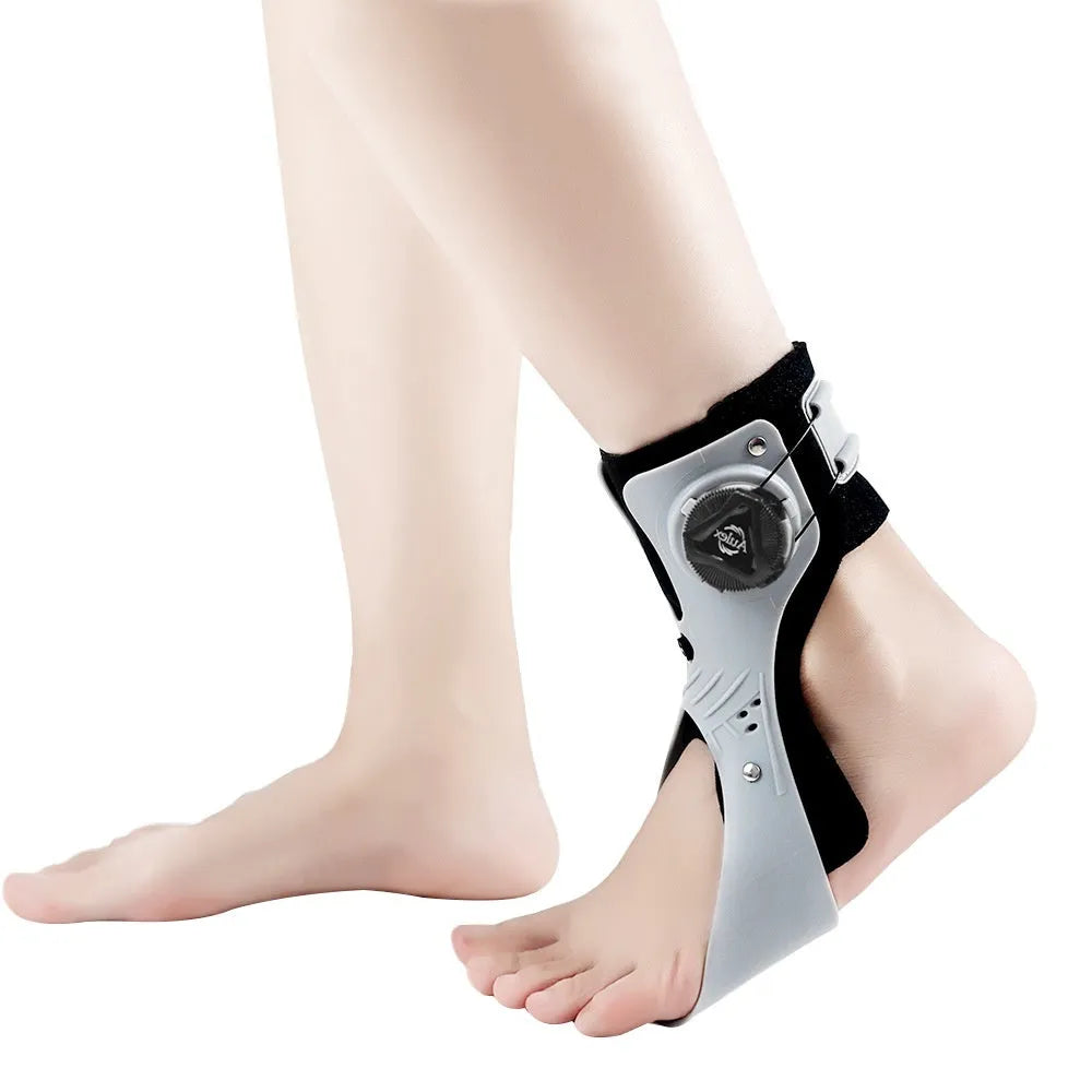 Grey ankle support brace with an airbag button adjustment system shown on a foot.
