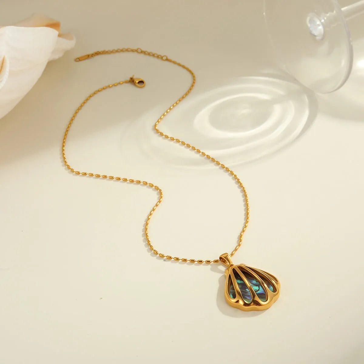 Gold plated stainless steel scallop shell stud earrings and necklace set with fan-shaped geometric design